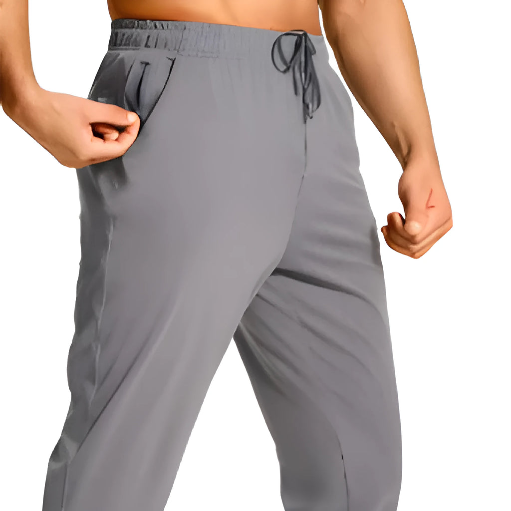 Men's loose fit casual polyester trousers in a solid colour, shown on a hanger.