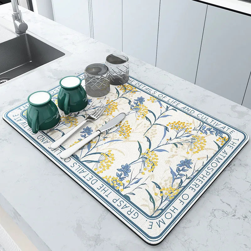 Square diatomite kitchen draining mat in camellia purple on a kitchen worktop, with a teacup resting on it