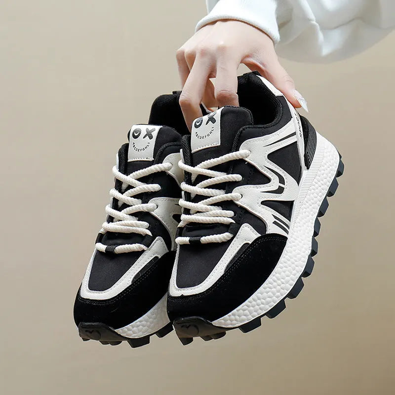 Women's flat-heel casual sports shoes in black with round toe and front lace-up design.