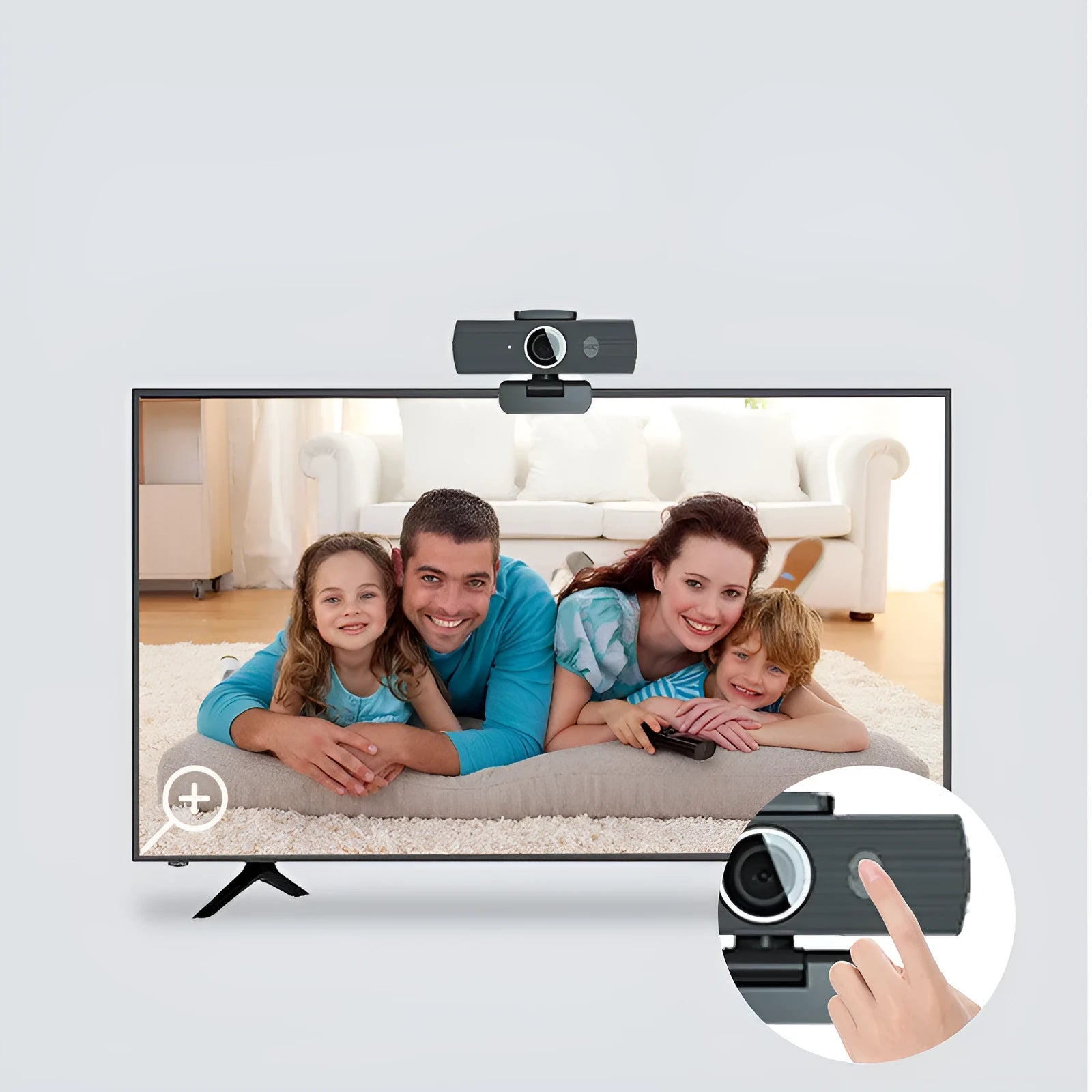 Black USB webcam with magnetic privacy cover on a desk next to a laptop.