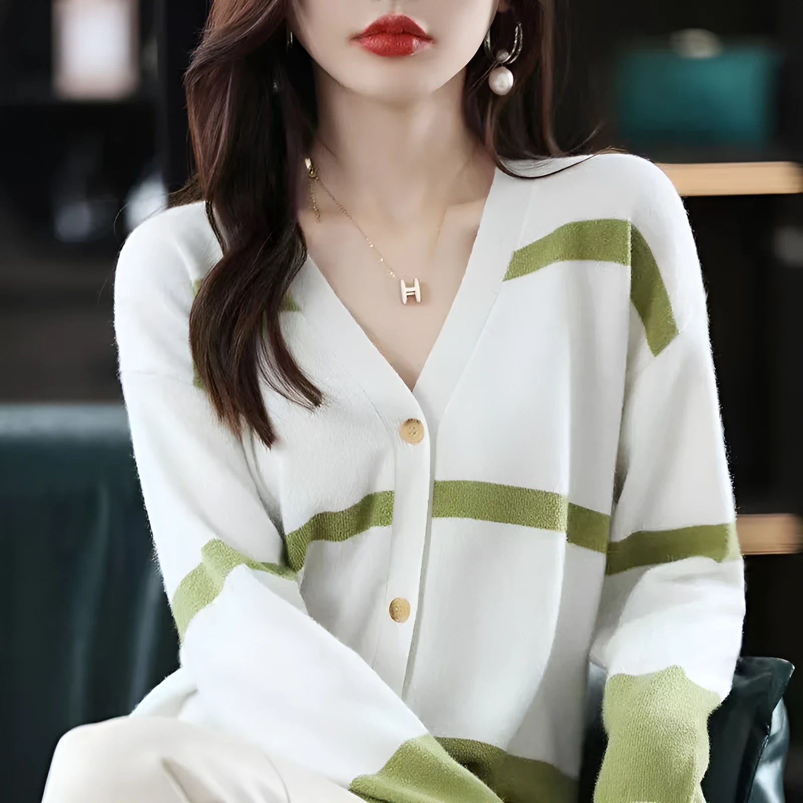 Women's black and white striped V-neck knitted cardigan with 3D pattern and buttons.
