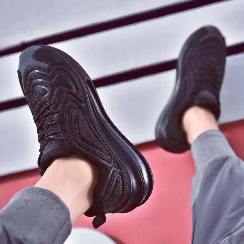 Men's black lace-up sneakers with thick sole and round toe on a white background