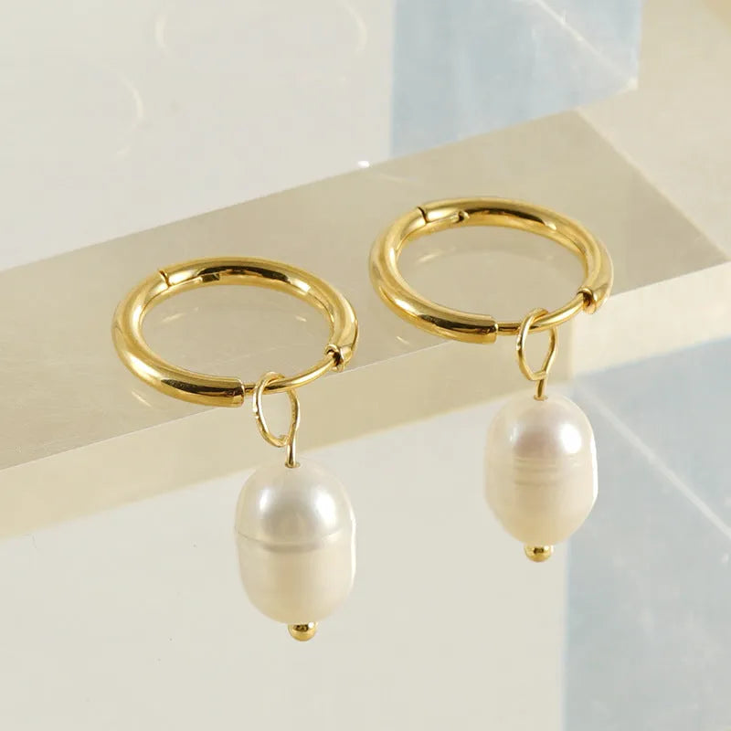 Gold geometric women's earrings with freshwater pearls on stainless steel and titanium posts.