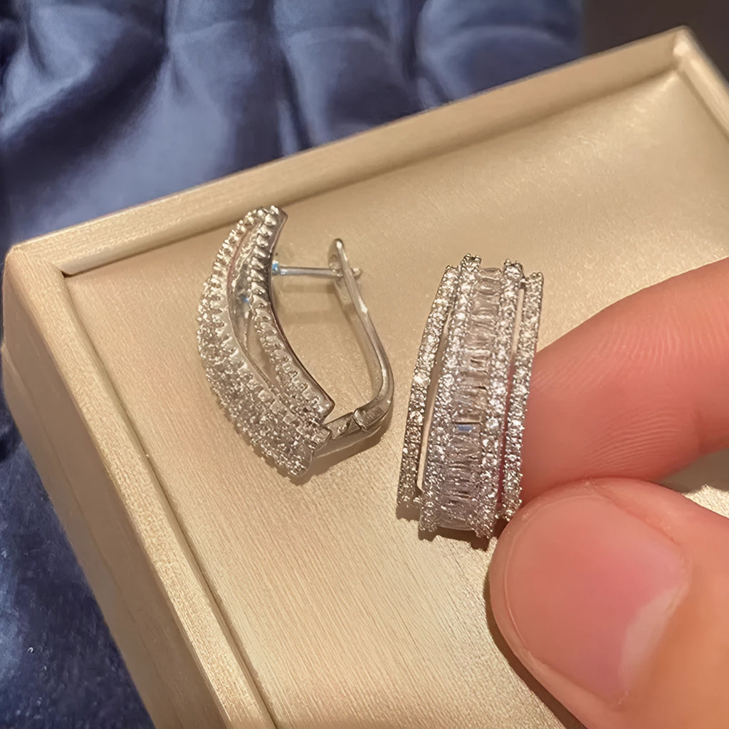 Women's geometric zircon stud earrings with white gold colour plating.
