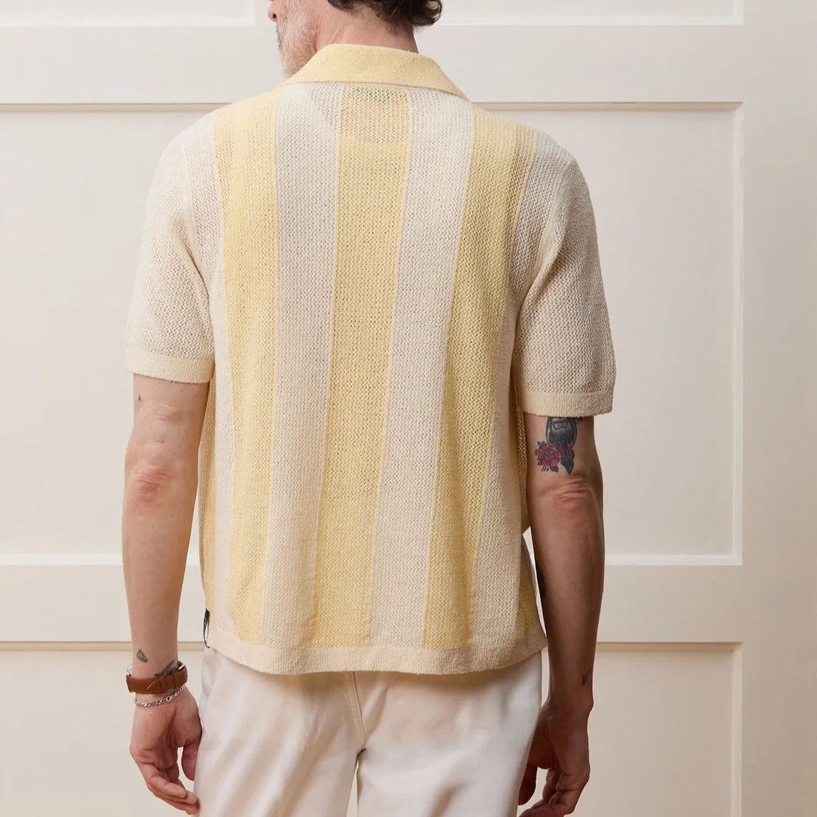 Yellow women's short-sleeved polo shirt with hollow-out asymmetric design, made from Tencel fabric.