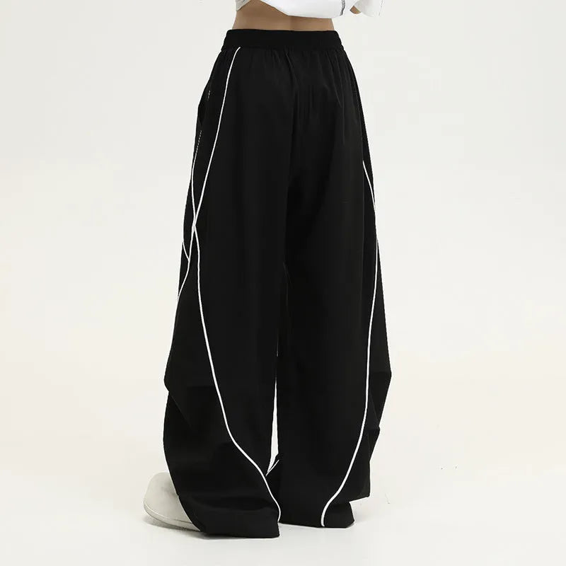 Black pleated hip hop trousers with wide-leg design and striped pattern