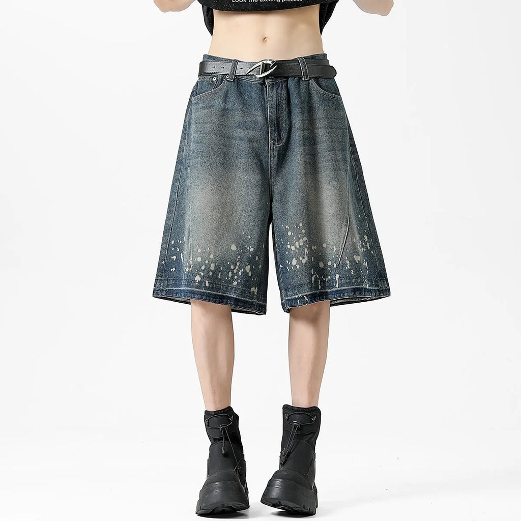 Retro blue denim shorts with distressed rip details and splash ink patterns, straight leg cut