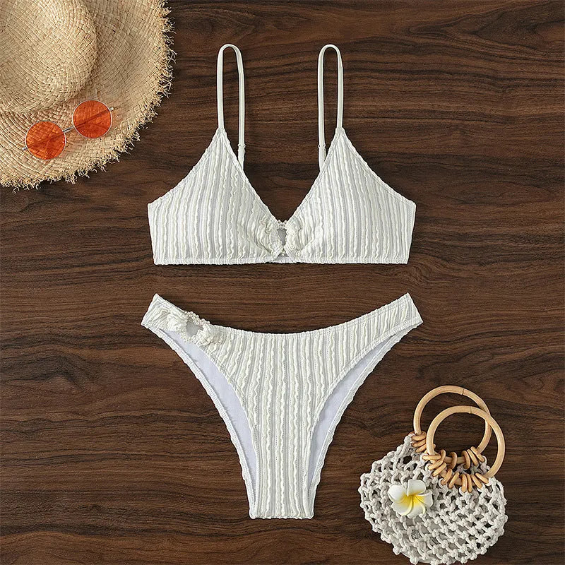 Women's white V-neck two-piece swimsuit set with sleeveless top and shorts on a mannequin.