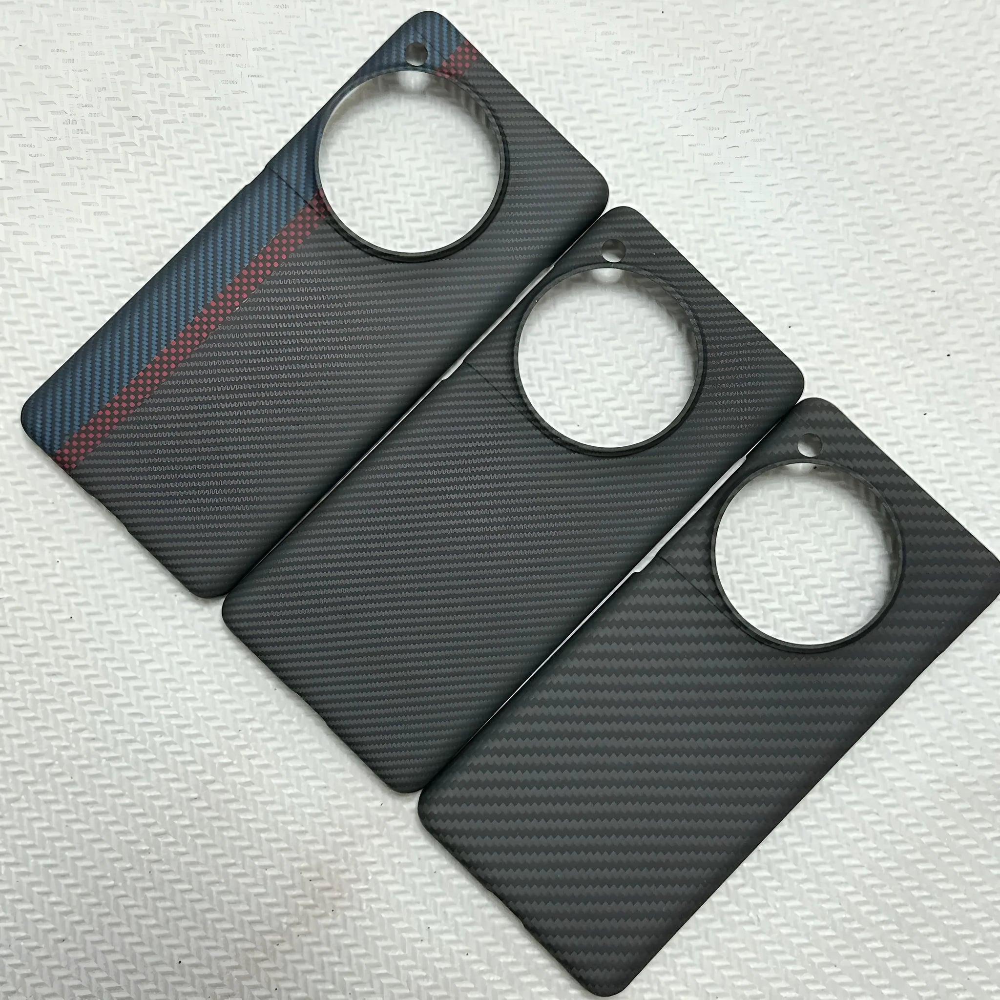 Black hand-woven Kevlar anti-wear phone case for OnePlus 12 with crater texture
