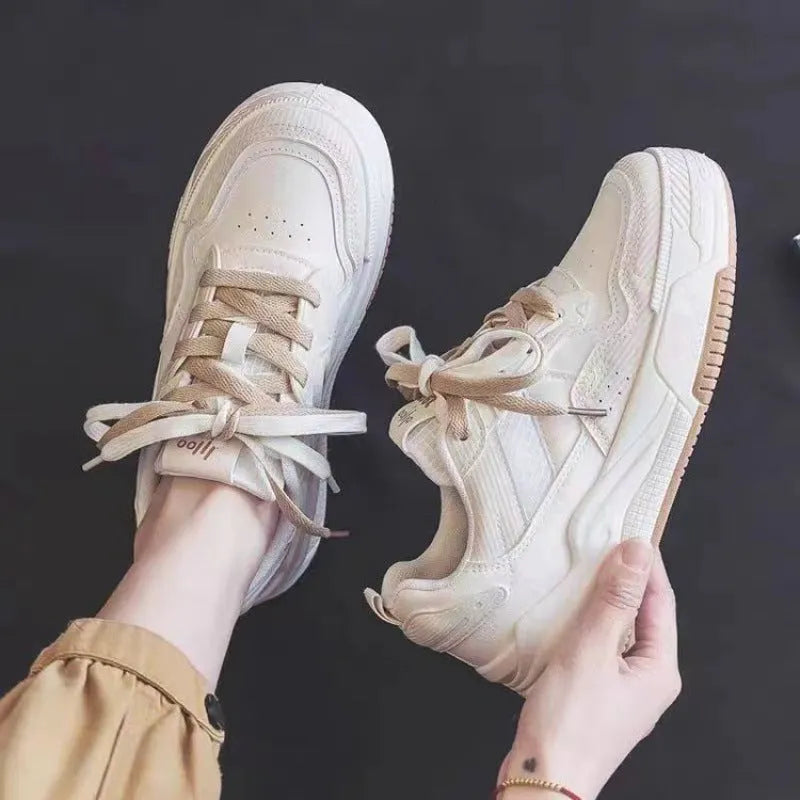 Beige and pink women's low top sneakers with a height increasing sole.