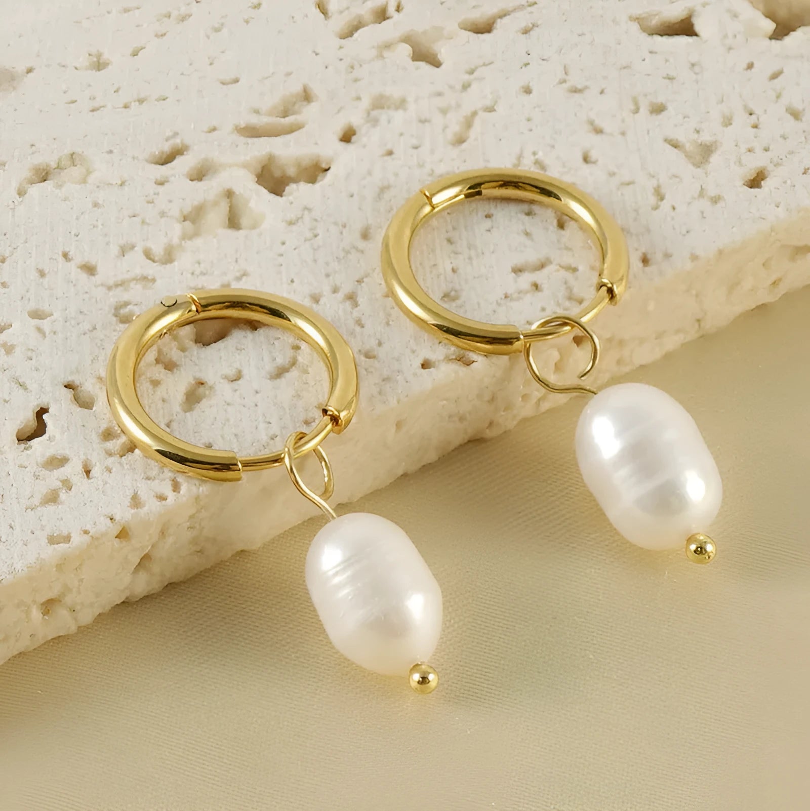 Gold geometric women's earrings with freshwater pearls on stainless steel and titanium posts.