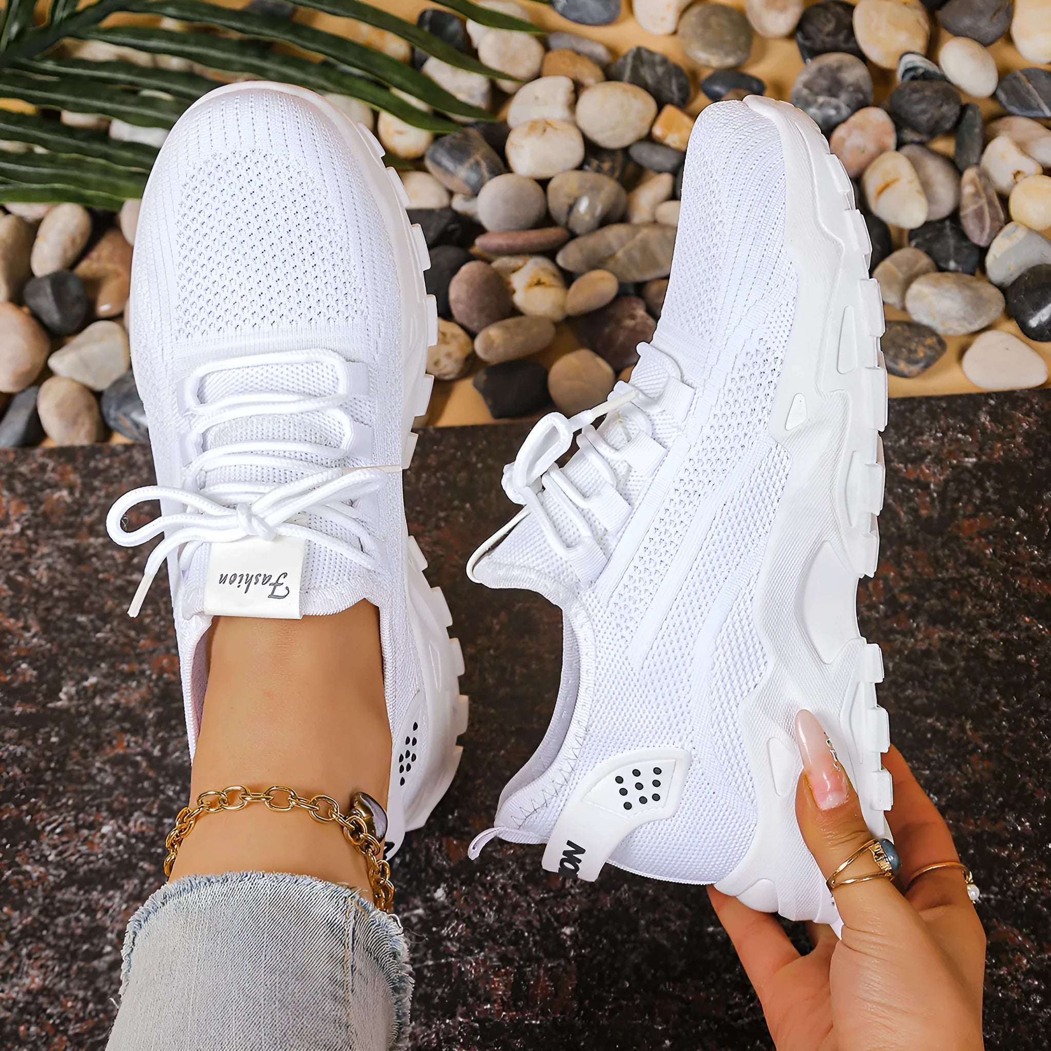 A pair of low-top Flyknit mesh casual trainers in a solid colour, featuring a platform sole and front lace-up closure.