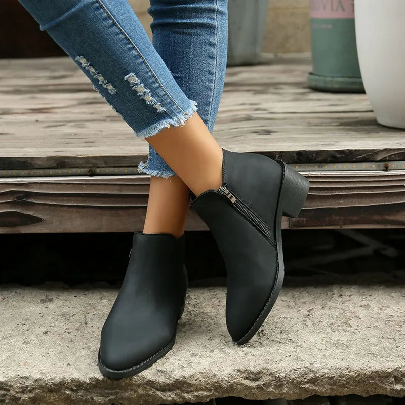 Women's chunky mid heel suede ankle boots with side zipper in off-white, front view