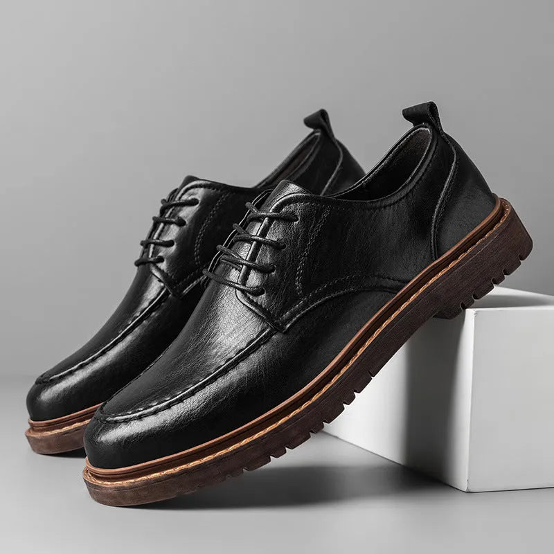 Men's black and brown casual leather slip-on shoes with round toe and visible sewing line detailing.