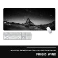 Oversized rubber mouse pad with gaming graphic design and wrist strap on desk
