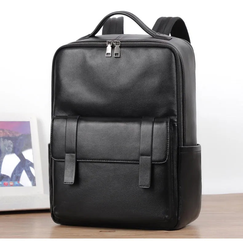 Men's black leather computer backpack showing front view with woven design elements