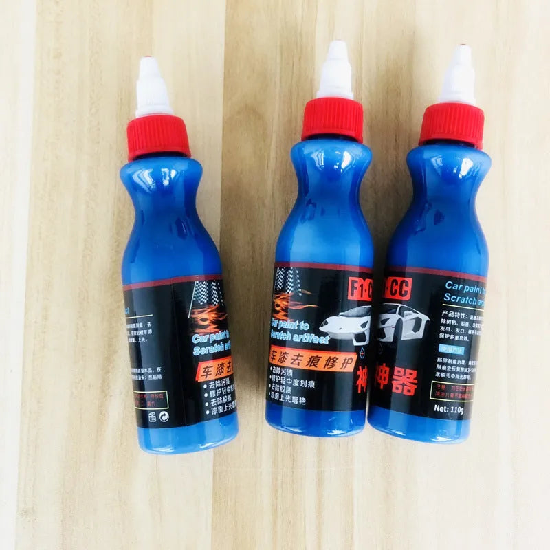 Small blue wiping tool and bottle of automotive scratch repair agent kit for car paint