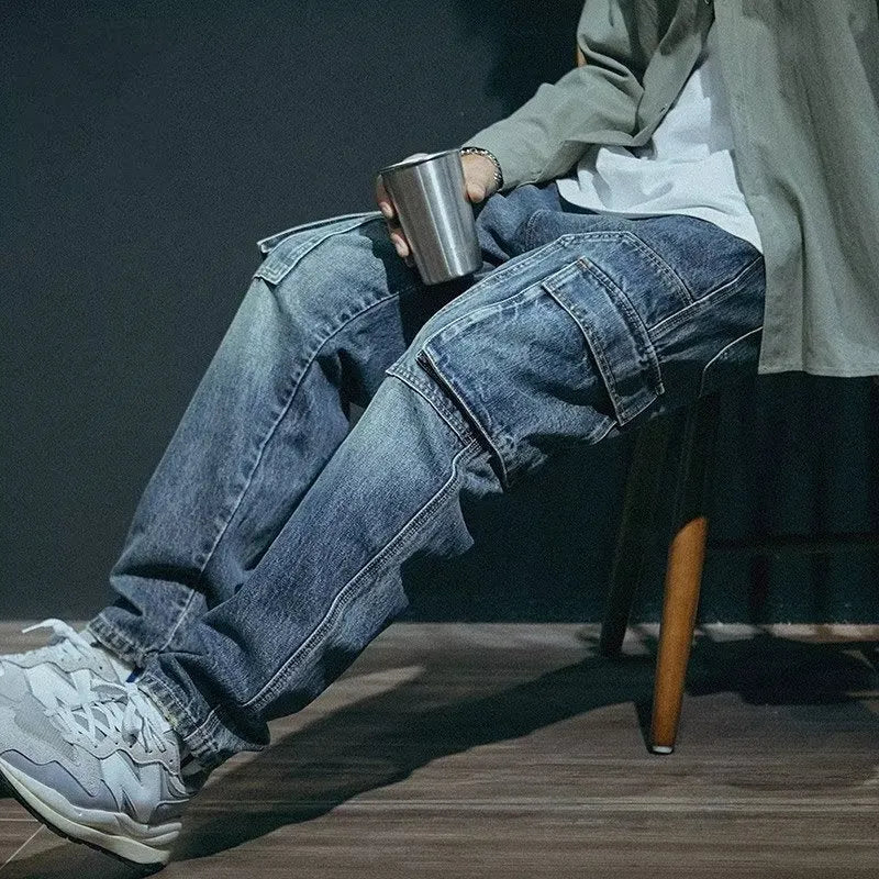 Blue men's loose straight-leg stretch jeans with a zip fly on a neutral background.