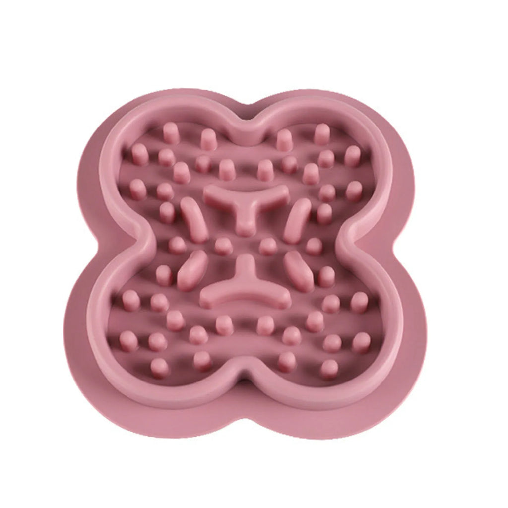 Silicone pet licking pad slow feeder mat in assorted colours on a floor