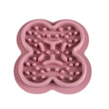 Silicone pet licking pad slow feeder mat in assorted colours on a floor