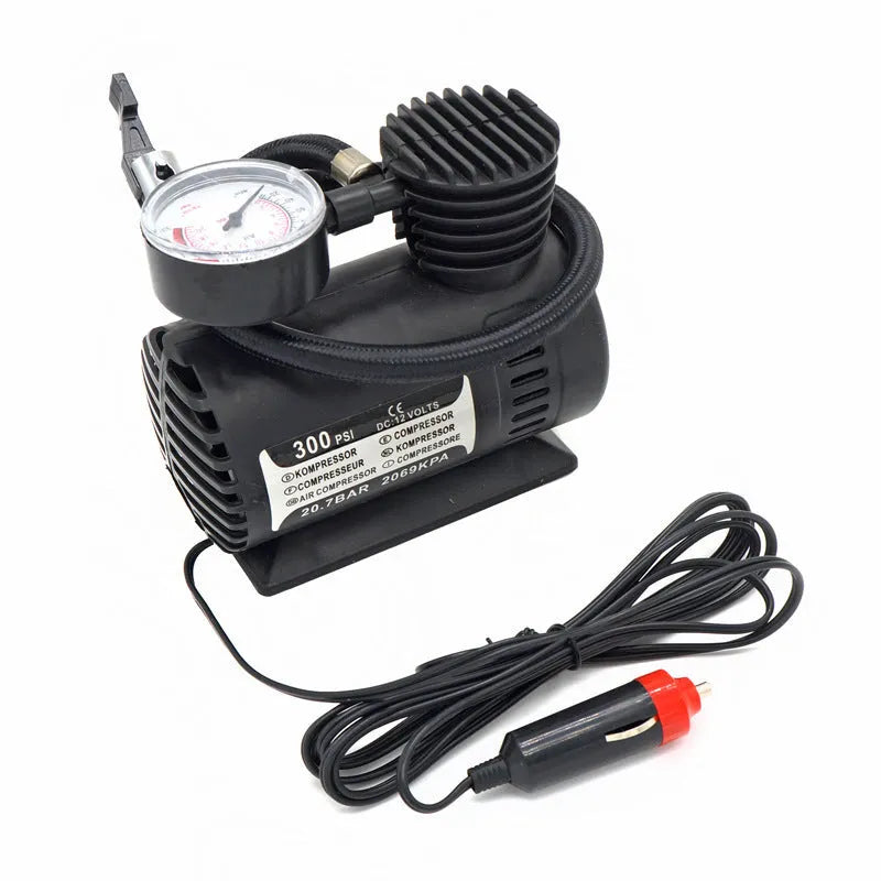 Black 12V portable mini air compressor with 300 psi gauge, 9-foot cord, and two adapter nozzles on a neutral background