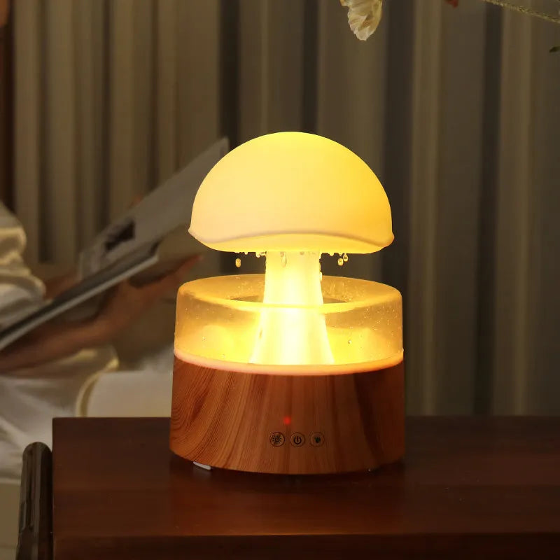 White rain cloud-shaped humidifier and essential oil diffuser on a surface