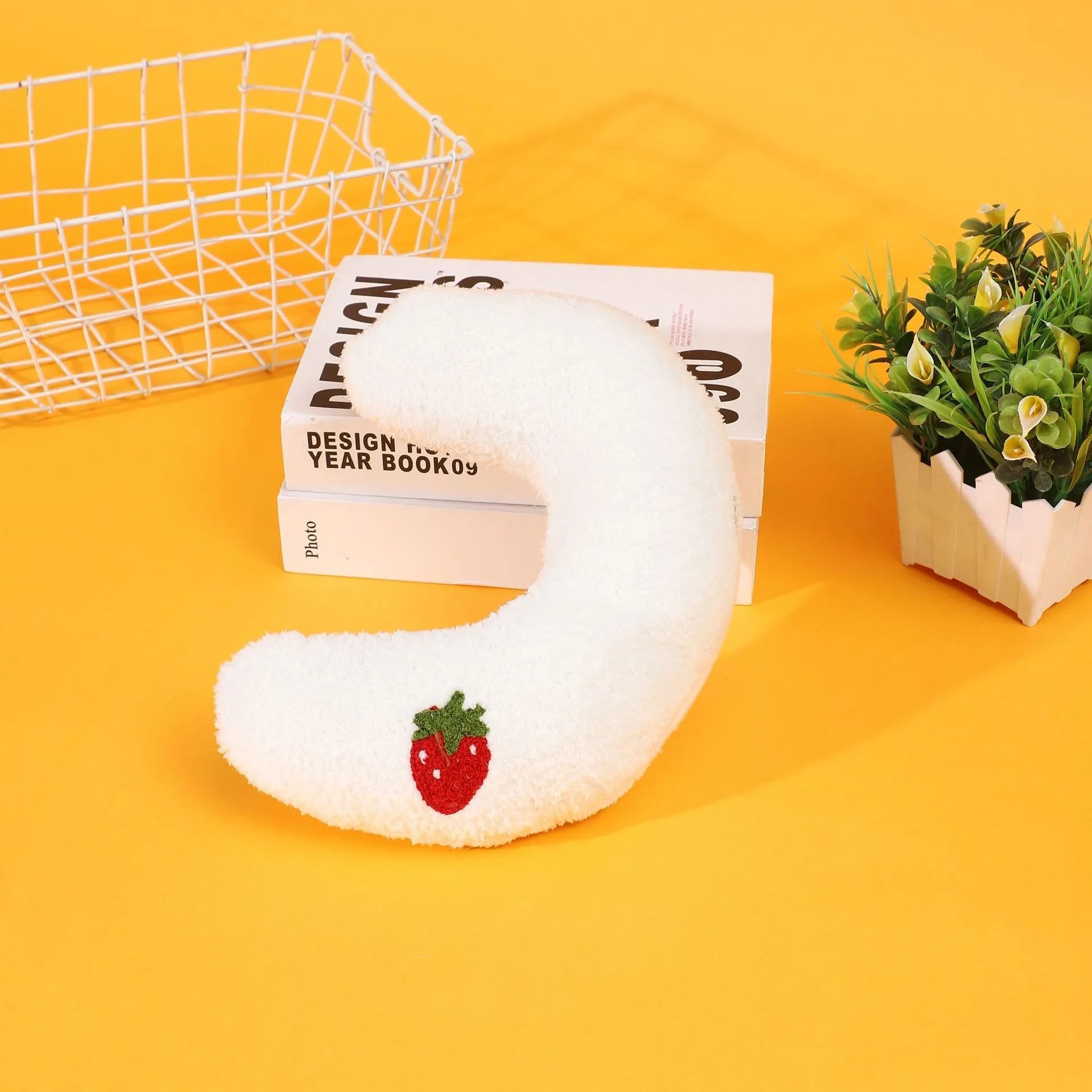 Half moon U-shaped cloth pillow for cats in blue, pink, white, and yellow colour options.