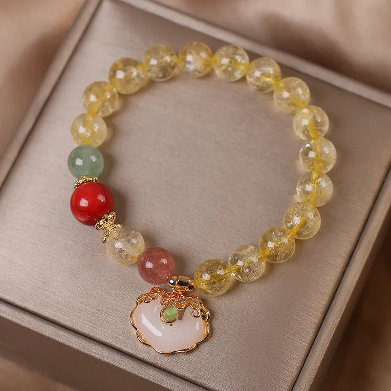 Women's bracelet with a citrine jade ruyi pendant and yellow hair crystal on an alloy band.