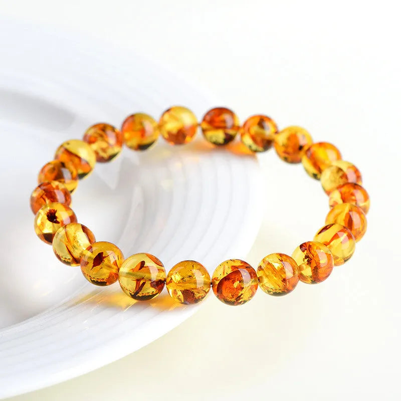 A geometric bead bracelet made from natural yellow piebald amber with flower spot patterning.