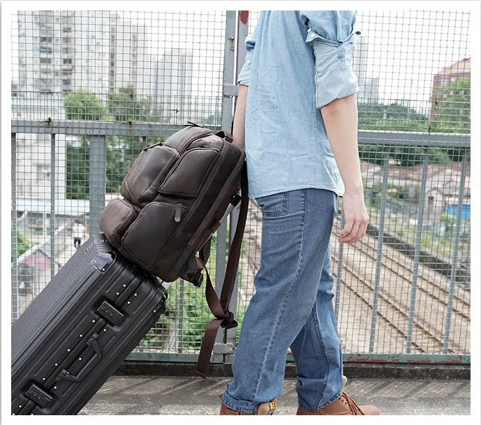 Dark brown retro crazy horse leather men's backpack with a 17-inch laptop compartment and double straps.