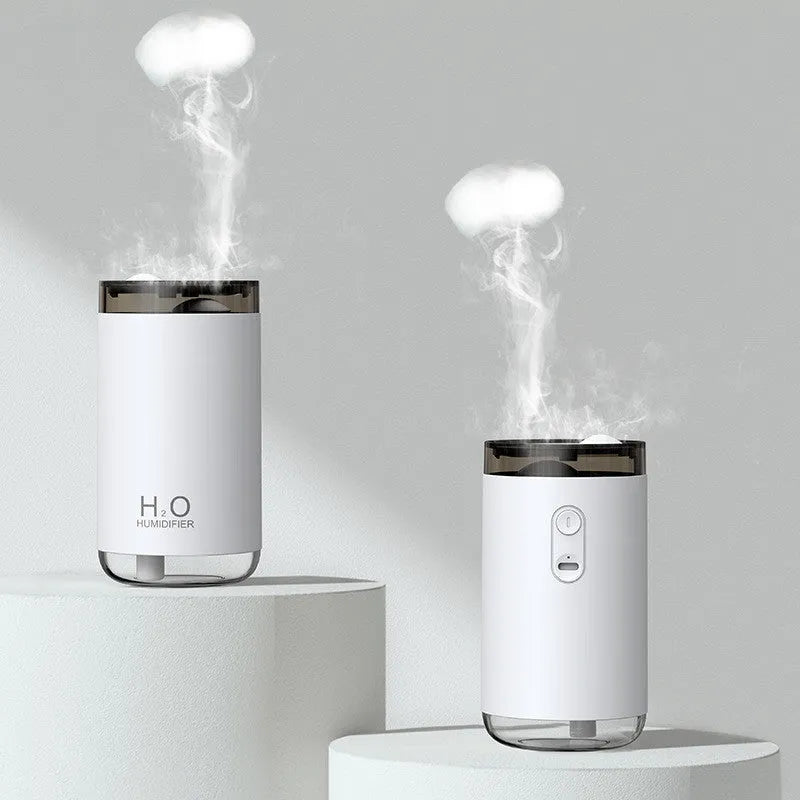 White USB humidifier with jellyfish spray mist effect and warm night light on a table.