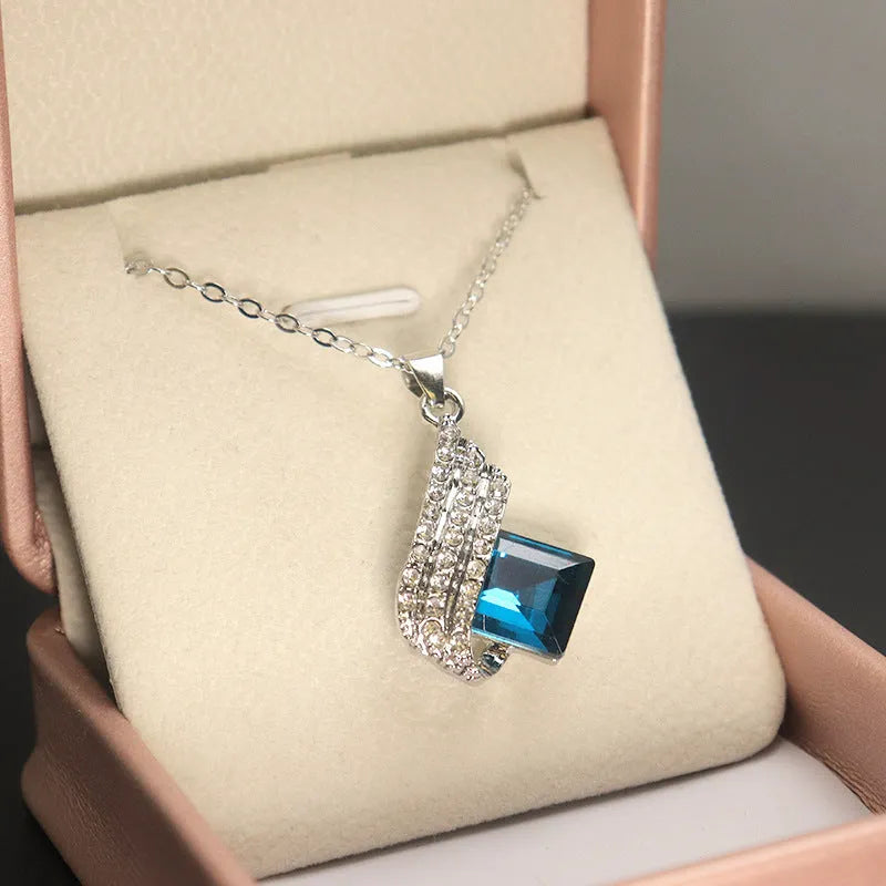 Glass pendant necklace with cross chain and matching electroplated alloy ear studs jewellery set