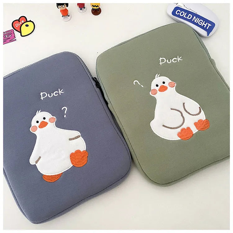 Blue cotton tablet case with embroidered cartoon duck design and zip closure