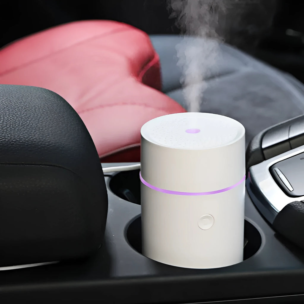 USB ultrasonic aroma diffuser 80ml with RGB LED lights in black, on a desk next to essential oil bottles