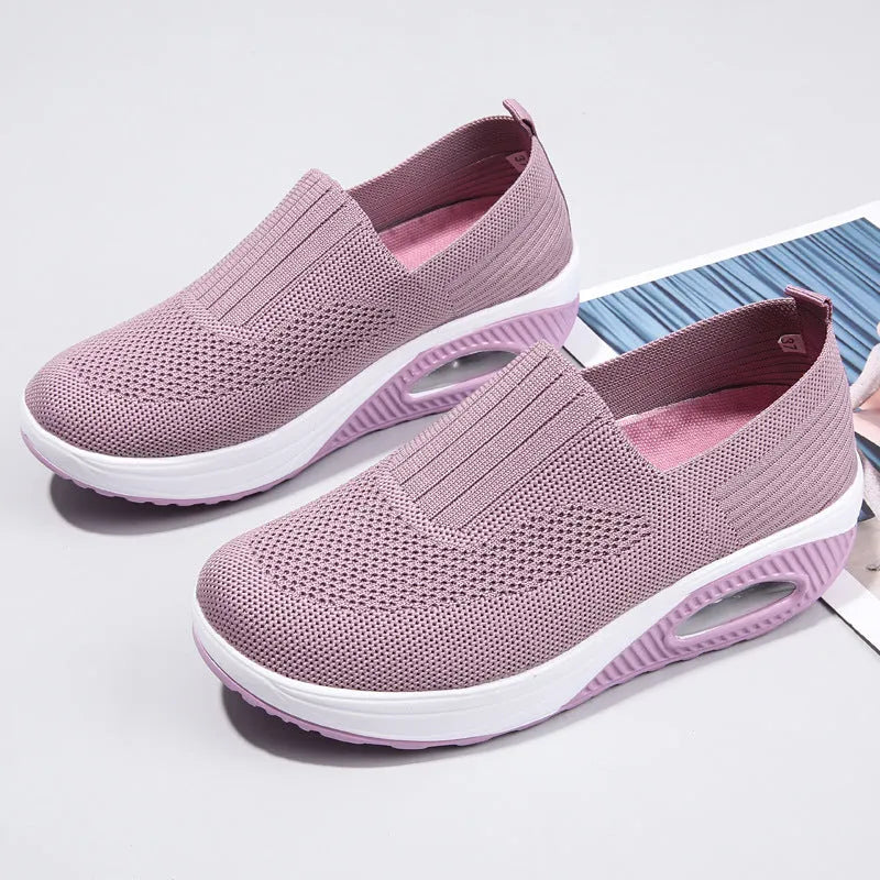 Women's beige artificial PU mesh running shoes with air cushion and round toe on a plain background.