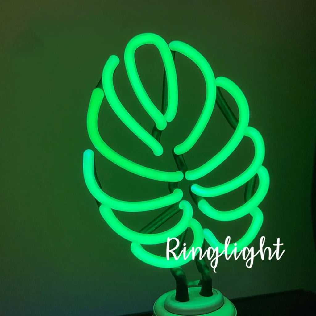 White bamboo-shaped desktop lamp emitting green light with USB power cable