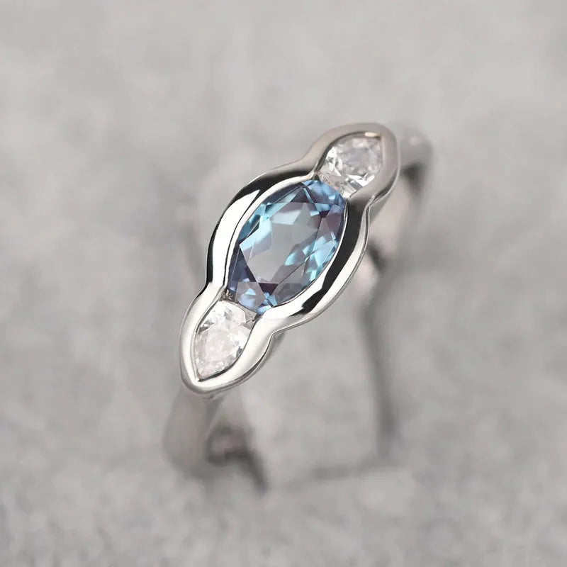 Women's geometric ellipse ring with inlaid zircon stones in white gold finish showing angular design details