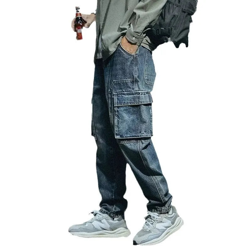 Blue men's loose straight-leg stretch jeans with a zip fly on a neutral background.