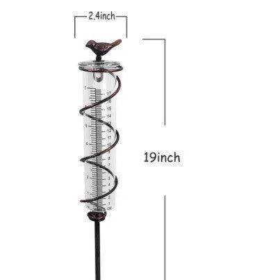 Cast iron bird-shaped outdoor rain gauge with glass measurement tube showing 0-800ml capacity scale.