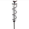 Cast iron bird-shaped outdoor rain gauge with glass measurement tube showing 0-800ml capacity scale.
