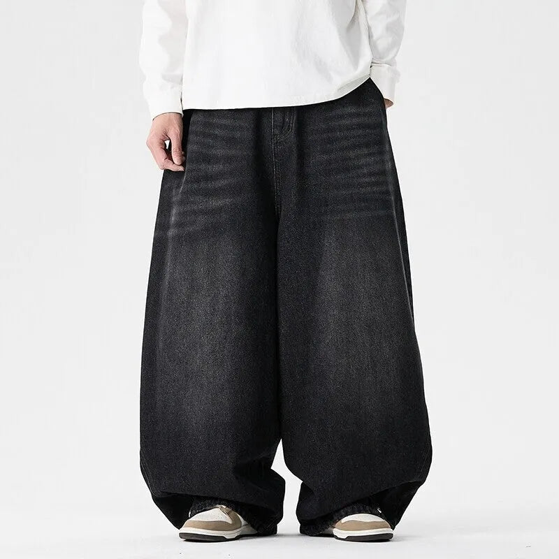 Men's plus size baggy jeans in light blue denim with wide straight legs and a low waist.
