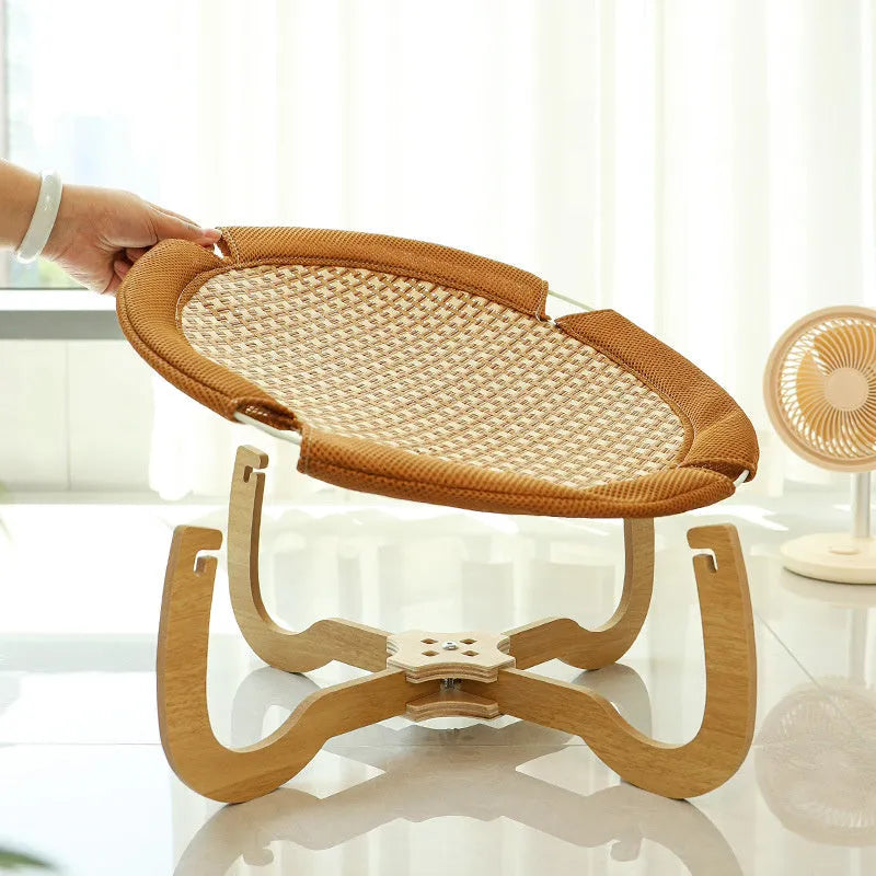 Brown woven rattan pet hammock bed for cats and small dogs on elevated stand