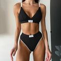 Women's grey bikini set with embroidery detail and contrast colour binding on a shorts-length bottom.