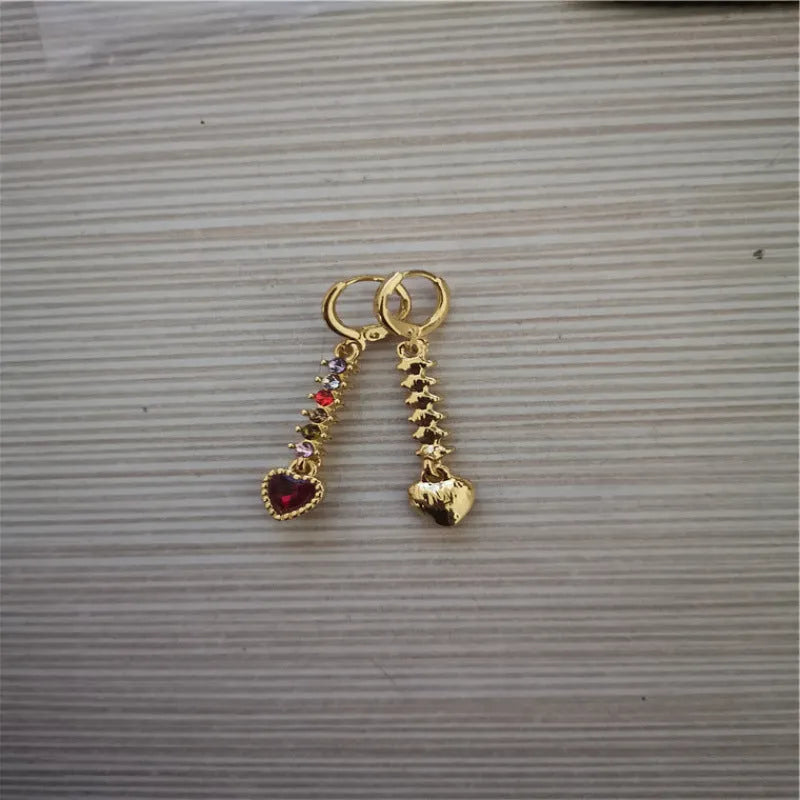 A pair of women's heart-shaped alloy earrings with a shiny electroplated gold finish.