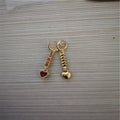 A pair of women's heart-shaped alloy earrings with a shiny electroplated gold finish.