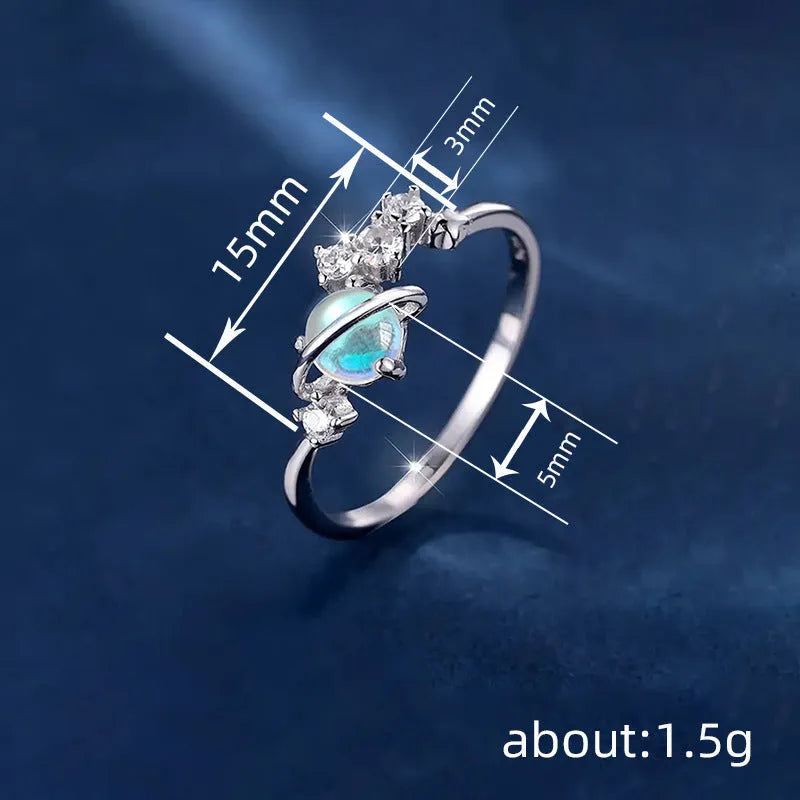 Geometric planet shaped copper ring with electroplated white gold finish on white background