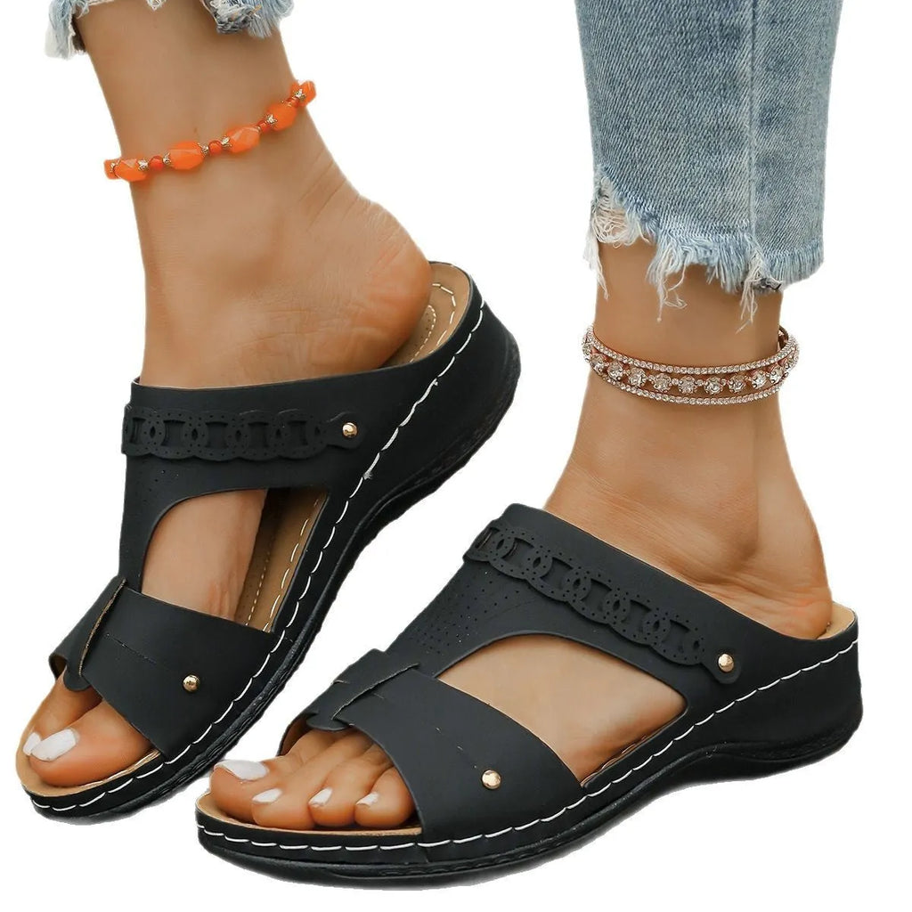 Blue roman style slippers with fish mouth toe and slope heel on a rubber sole.