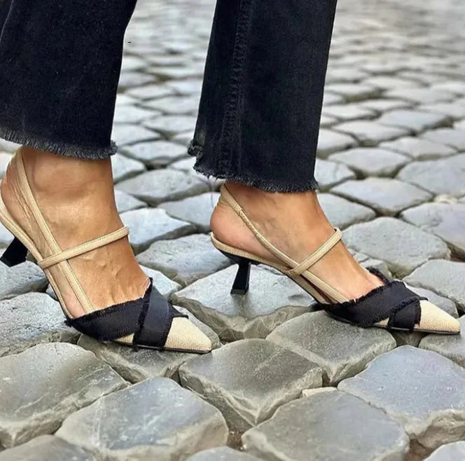 Apricot and black colour block women's sandals with a stiletto heel and buckle fastening.