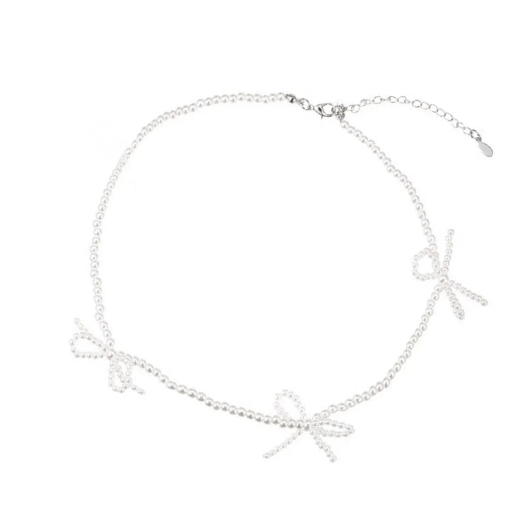 White adjustable pearl necklace with bow detail measuring 31-40cm