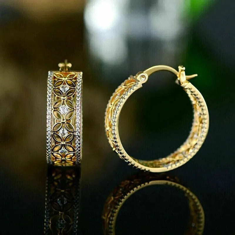 Yellow gold geometric copper earrings with horse eye, flower and butterfly motifs, clip-on back visible